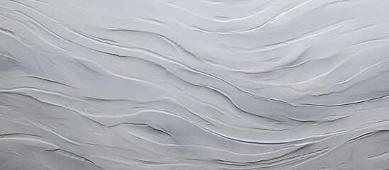 A close up of a peachcolored wall with a wave pattern resembling wood grain. The sloping landscape is frozen in time, mimicking rocky flooring