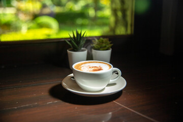 Your favourite morning cup of Cappuccino coffee by the window