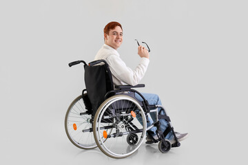 Office worker in wheelchair with eyeglasses on light background