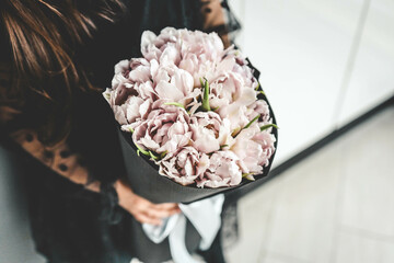 Girl with a bouquet of pink tulips close-up