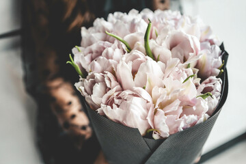 Girl with a bouquet of pink tulips close-up