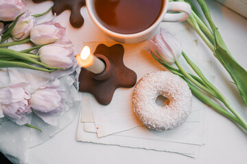 Fototapeta na wymiar Donut and tea in a spring atmosphere