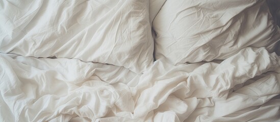 Rumpled white bedding in a bedroom.