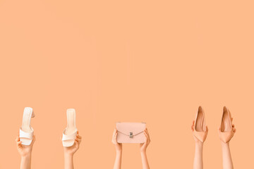 Women with stylish shoes and bag on beige background