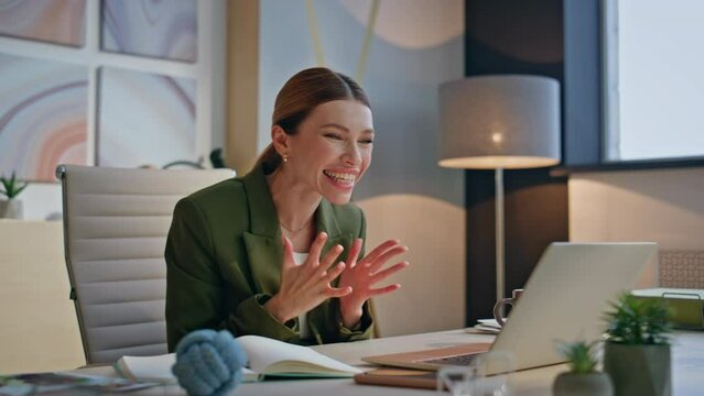 Excited woman reading great news on laptop screen sitting luxury office closeup