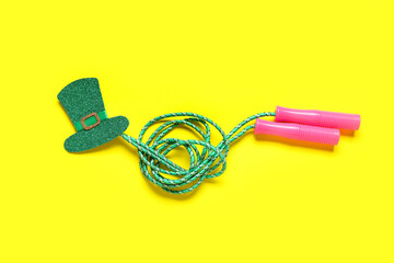 Skipping rope with leprechaun's hat on yellow background. St. Patrick's Day celebration