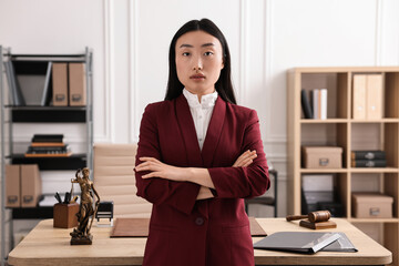Portrait of notary with crossed arms in office