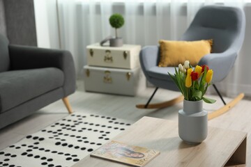 Beautiful tulips in vase on coffee table indoors, space for text