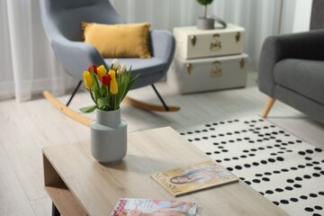 Beautiful tulips in vase on coffee table indoors, space for text
