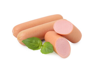 Whole and cut delicious boiled sausages with basil on white background