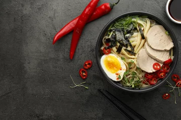 Foto op Plexiglas Delicious ramen with meat in bowl and ingredients on grey textured table, flat lay. Space for text. Noodle soup © New Africa