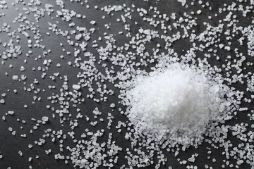 Foto op Plexiglas Heap of natural salt on black table, top view © New Africa