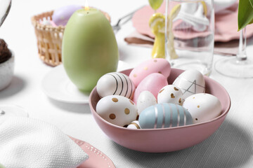 Obraz na płótnie Canvas Festive table setting with painted eggs, closeup. Easter celebration