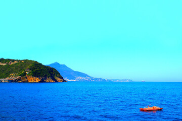 Serene scenery from Isola di Procida in the Gulf of Naples with the weaving rippled waves of the...