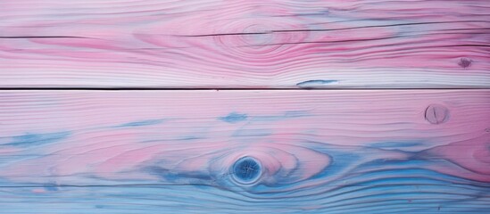 A detailed shot of a watercolor painting on a wooden surface, featuring a blend of pink, blue, and purple hues resembling a tranquil sky reflecting on a lake - Powered by Adobe
