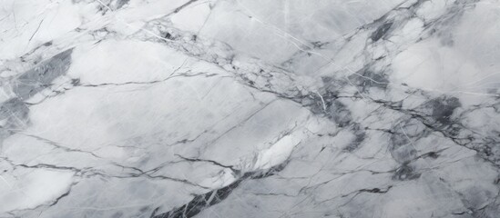 Obraz premium A close up of a grey marble texture resembling a snowy landscape with a slope. The pattern looks like automotive tire tracks on wood or twig in freezing weather
