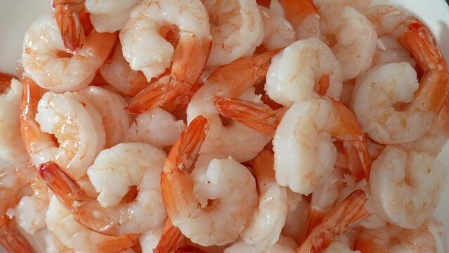 Shrimp: low calorie, fat, high protein, nutritious. Rich in selenium, vit. B12, phosphorus, iodine. Higher cholesterol than some seafood options. Food concept. Seafood background. 4K.