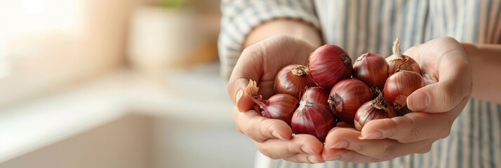 Hand holding red onion with blurred background, onion assortment with space for text - obrazy, fototapety, plakaty