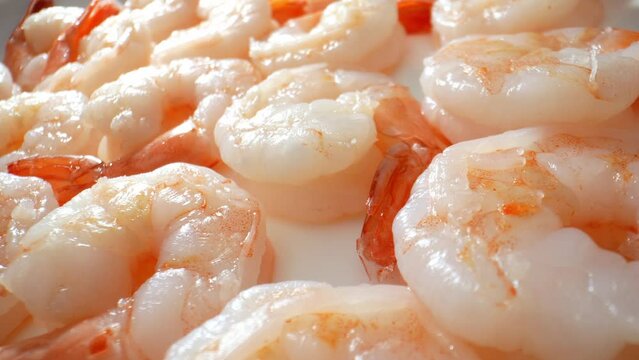 Cooked shrimp embody culinary excellence, blending exquisite flavor, texture, and versatility in every bite. Whether standalone or in gourmet dishes, they captivate the palate and elevate dining. 4K.
