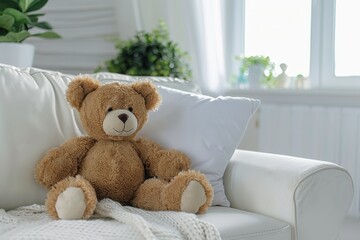 Soft plush teddy bear on a white couch