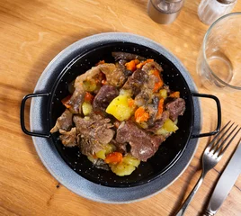 Foto op Plexiglas Appetizing beef stew served with potatoes and mushrooms on platter © JackF