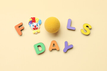 Text FOOLS DAY with clown nose on beige background