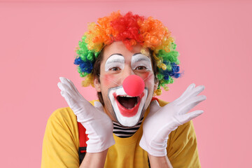 Portrait of happy clown with on pink background. April Fool's day celebration
