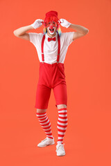 Portrait of clown with novelty glasses on orange background. April Fool's day celebration