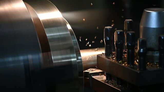 Slow motion close up flying chip on the  lathe machine finish cut the brass material parts.