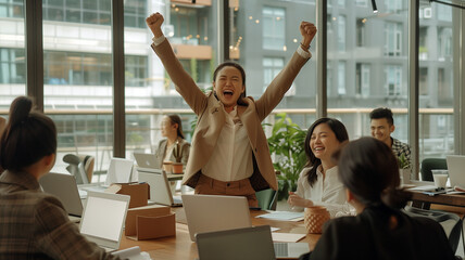 A group of business people are celebrating their success in an office setting, with one person holding up her fist and smiling at the camera. - obrazy, fototapety, plakaty