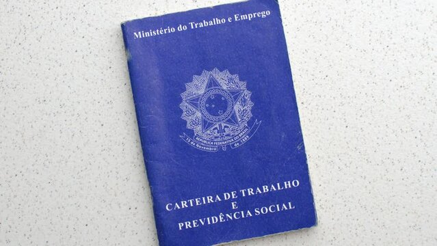 Brazilian Work ID. Unemployment, job, or salary increase. On a clear surface: Employment symbols reflected on the ID, depicting the pursuit of opportunities, laid on an illuminated table.