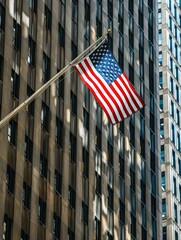 American flag waving against skyscrapers - Patriotic image of an American flag waving in front of modern skyscrapers symbolizing power and freedom