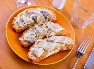Fotobehang Light and healthy breakfast - sandwiches of bran bread and herring, decorated with ring of garden onion, sprinkle with spices, dried Provencal herbs © JackF