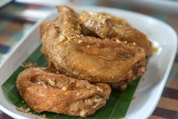 Close up fried chicken wings served on banana leaf