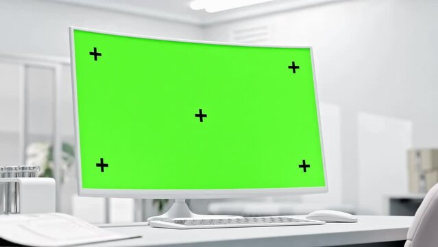 Computer MockUp. Animation, 3D Render. Empty desktop computer on work desk in laboratory or white room. Can be used in  erelated to science, education, or technology. Green screen for banner and logo.