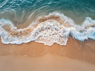 Foto op Plexiglas sunset over the sea, waves on the beach © Anuson