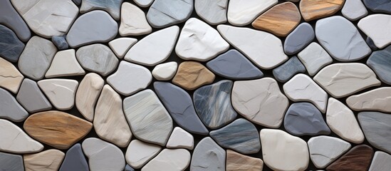 A detailed shot of a stone wall showcasing a mix of colored rocks. The variation in colors creates a beautiful pattern, ideal for landscaping or as a building material - Powered by Adobe