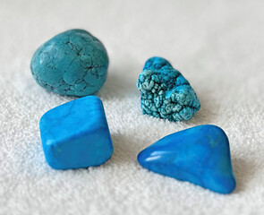Turquoise stones for jewelry, health and spirituality. Set of differently shaped turquoises, raw and polished stone.