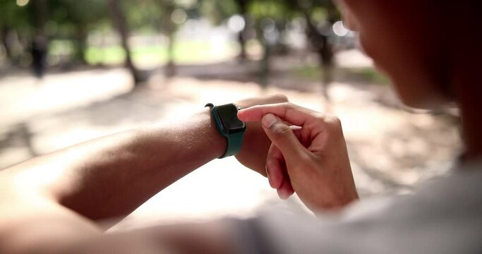 Fitness, hands or runner in park with smart watch for heart rate to monitor training or cardio exercise. Nature, race progress or healthy man on break with technology or timer app in running workout