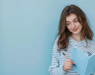 Obraz premium Smiling Teenage Girl with Notebook