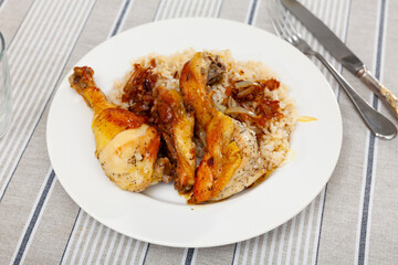 Appetizing pieces of fried chicken with rice on platter
