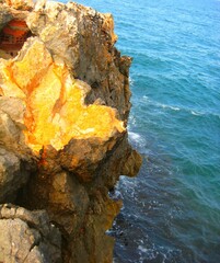 Waves crashing on seashore rocks, Top view sea surface waves background