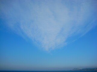 Blue sky with white, soft clouds and horizon in Spain