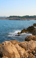 Fototapeta na wymiar Wave breaking on the rocks in the coast of sea in Girona, Spain