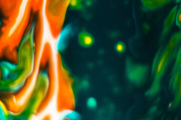 Colorful abstract background. Multi-colored spots on a black background.