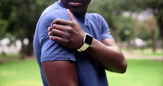 Exercise, shoulder pain and man in a park, injury and workout with inflammation, broken or muscle tension. African person, athlete or runner with emergency, bruise and health crisis with fibromyalgia