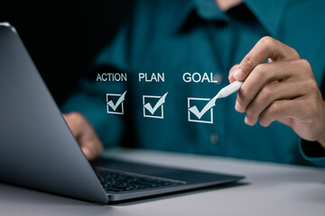 Goal, plan and action concept. Business strategy and business development. Businessman using laptop to checking mark on checkboxes on virtual screen.