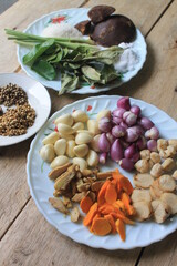 Various kinds of Indonesian cooking spices in plates on the table