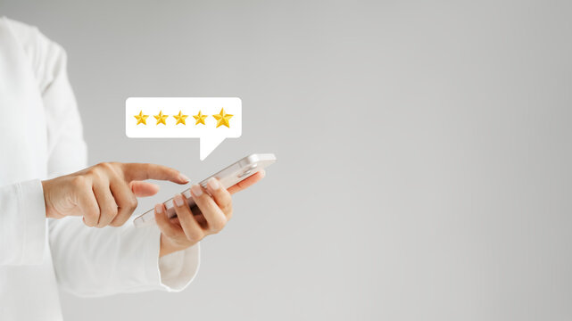 customer satisfaction survey concept businesswoman use smartphone Touch the happy smiley icon. Satisfied. 5 stars. Service experience rating. online application Satisfaction Review best quality..