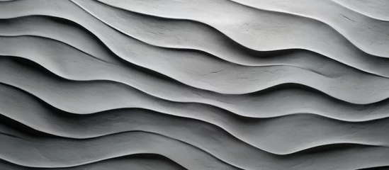 Fotobehang A closeup of a rectangular gray wave pattern on a wall resembling an aeolian landform, creating a unique and artistic landscape © 2rogan